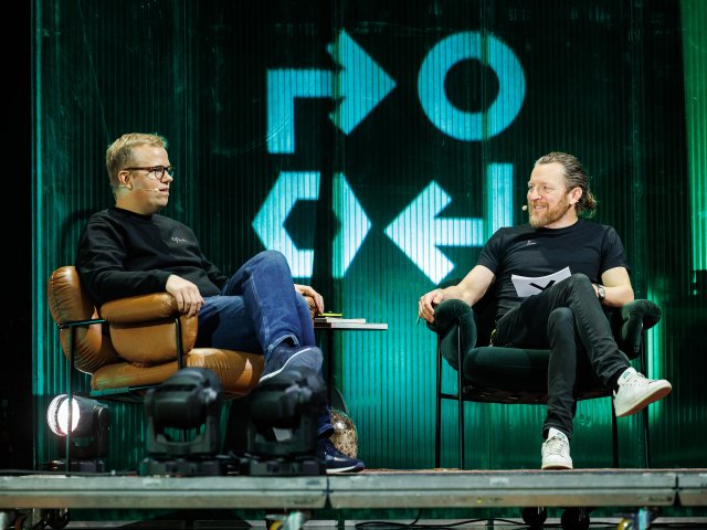 Two people sitting on stage