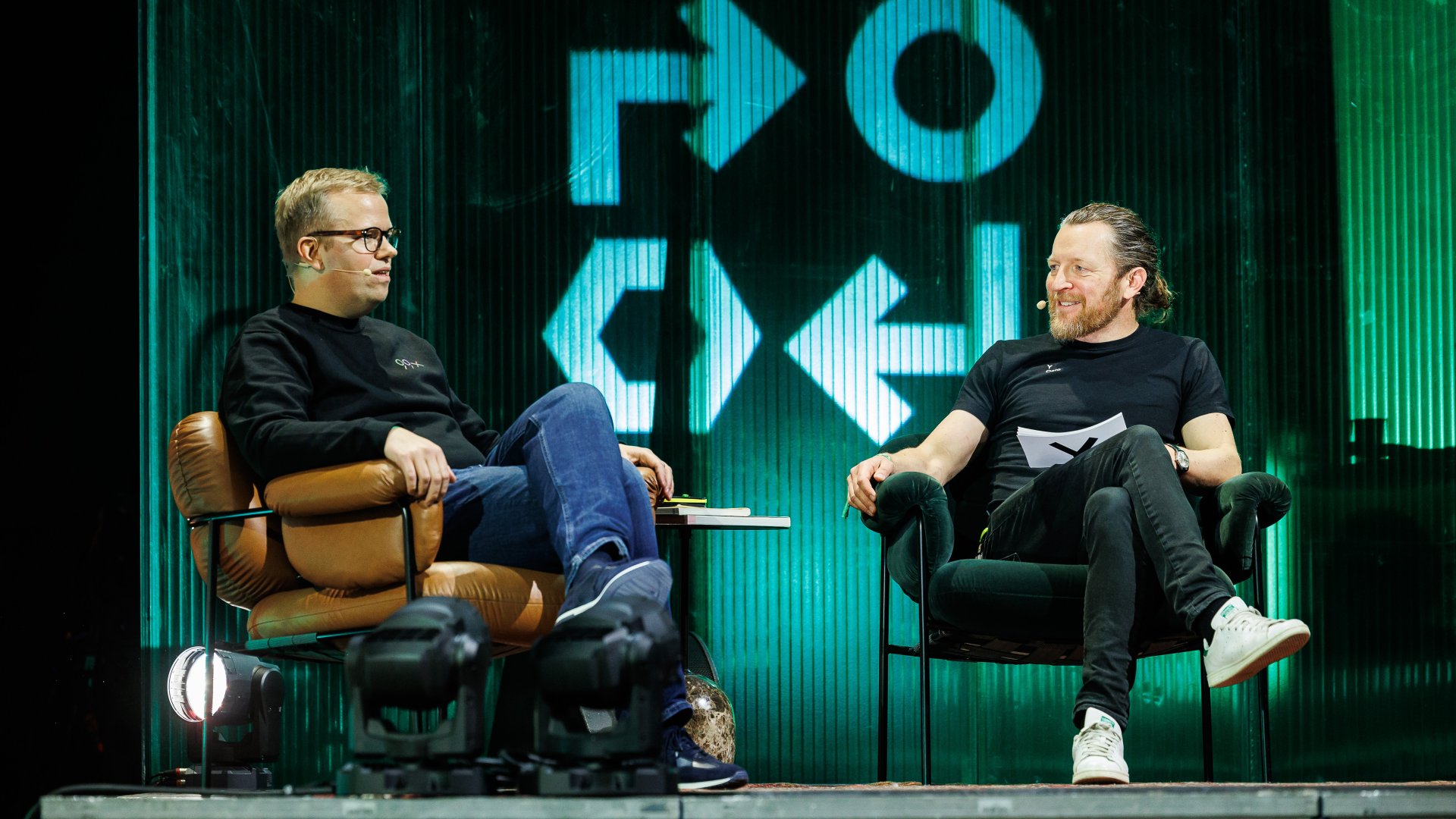 Two people sitting on stage
