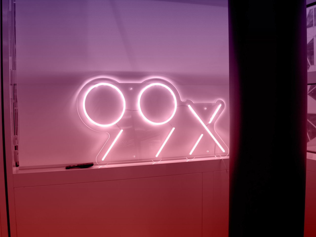 99x logo in the window sill at the office