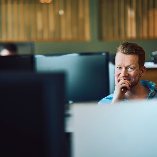 Man sitting infront of a computer screen
