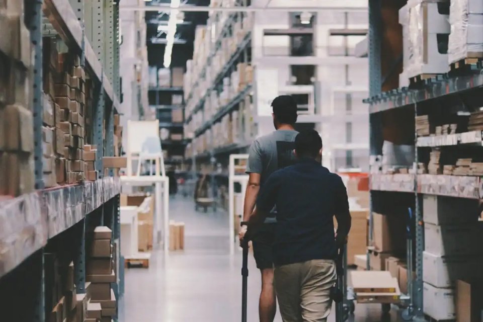 two-people-walking-through-a-warehouse - moter two-people-walking-through-a-warehouse - moter