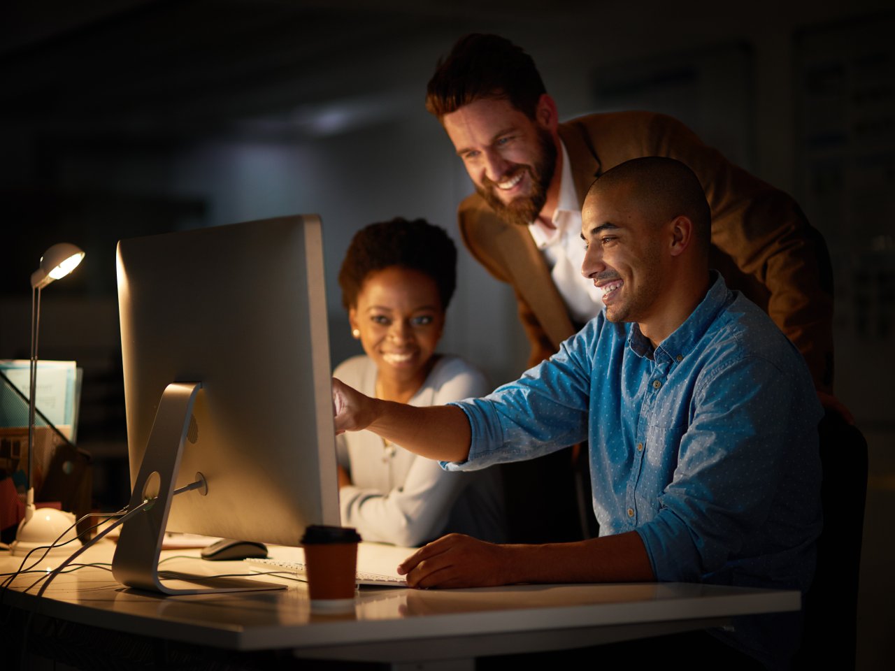 Cropped shot of a group of colleagues working late in an office