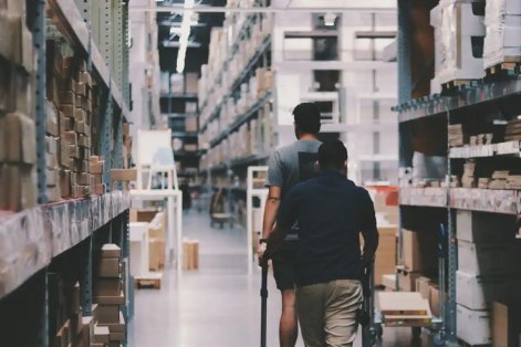 two-people-walking-through-a-warehouse - moter two-people-walking-through-a-warehouse - moter