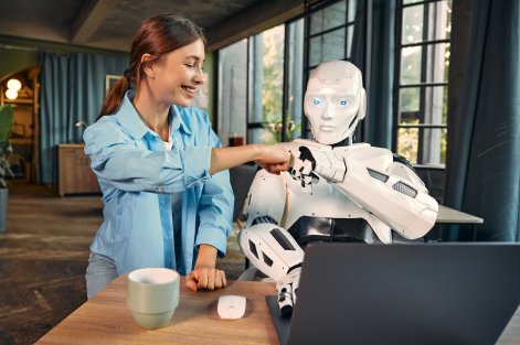 robot-and-woman-working-on-laptop-in-office-2023-11-27-05-32-05-utc