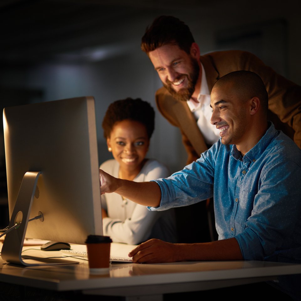 Cropped shot of a group of colleagues working late in an office