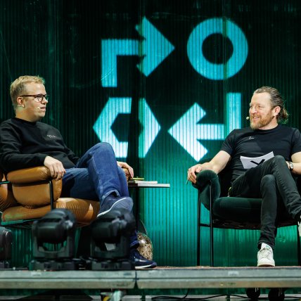 Two people sitting on stage