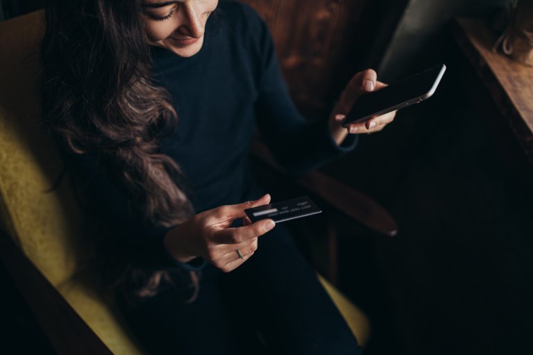 Young woman shopping online with her smartphone