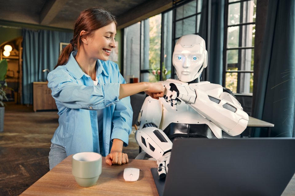 robot-and-woman-working-on-laptop-in-office-2023-11-27-05-32-05-utc robot-and-woman-working-on-laptop-in-office-2023-11-27-05-32-05-utc